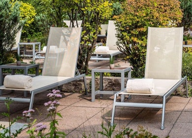 Outdoor lounge chairs with towels at Pullman Fit & Spa Lounge, Stuttgart, Baden-württemberg, DE.