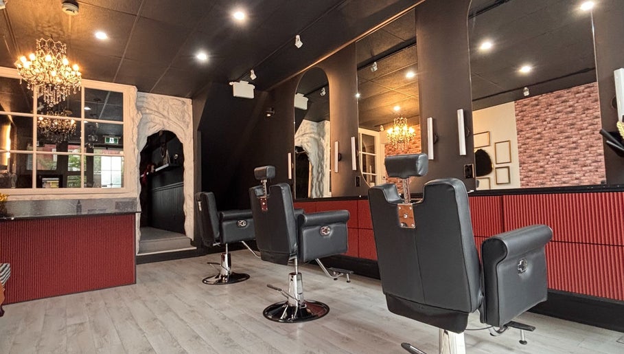Chic interior of The Masque Atelier, Toronto, Ontario, CA, showcasing stylish salon chairs and ambient lighting.
