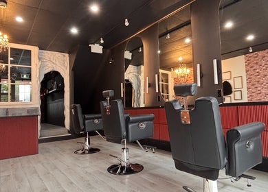 Chic interior of The Masque Atelier, Toronto, Ontario, CA, showcasing stylish salon chairs and ambient lighting.
