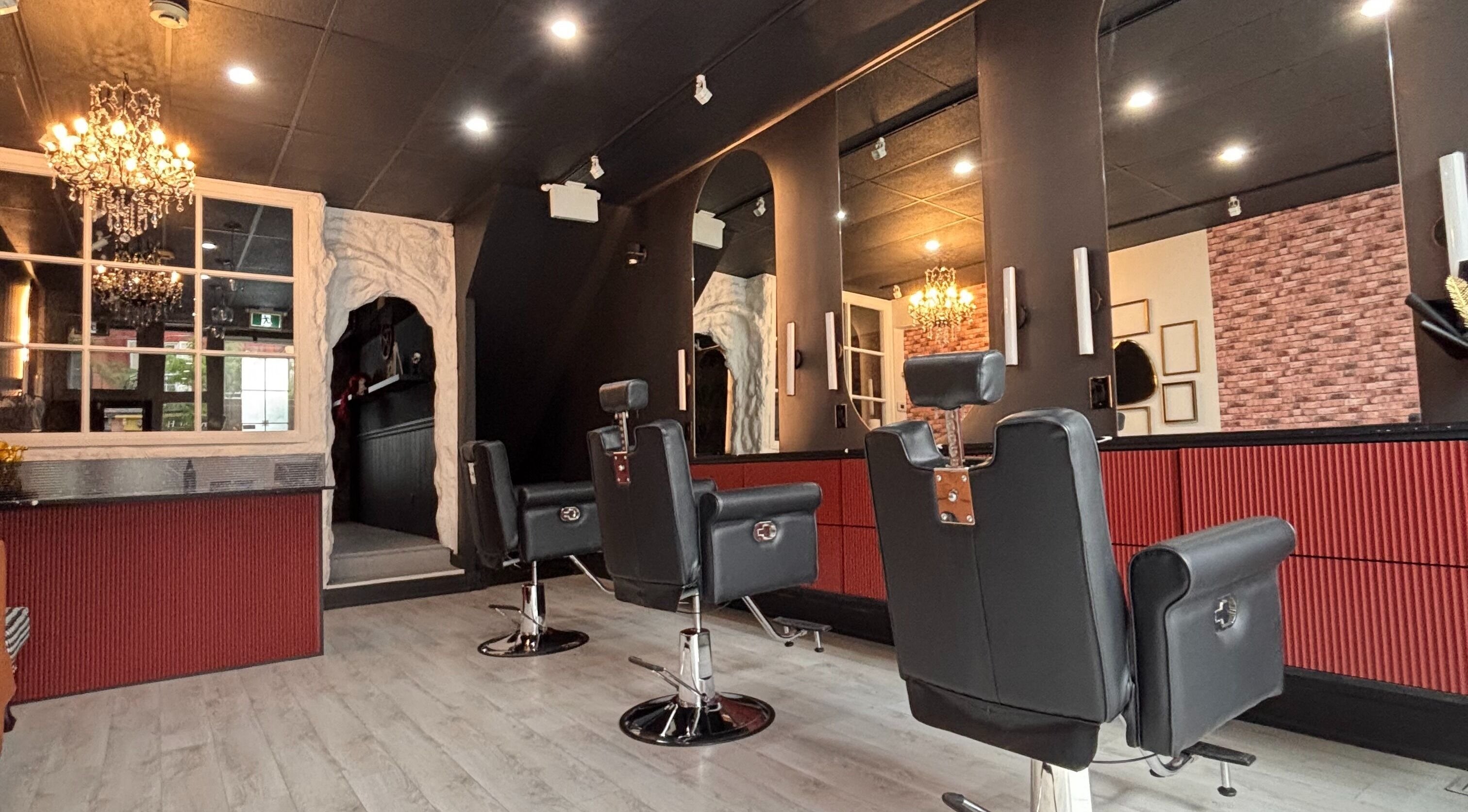 Chic interior of The Masque Atelier, Toronto, Ontario, CA, showcasing stylish salon chairs and ambient lighting.