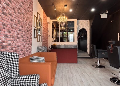 Stylish interior of The Masque Atelier in Toronto, Ontario, CA with chic seating and a chandelier.