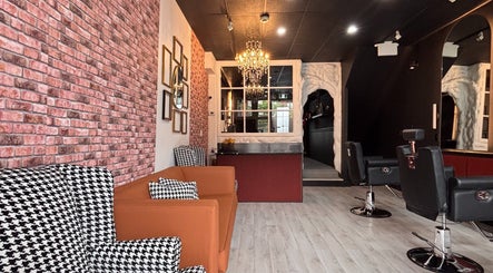 Stylish interior of The Masque Atelier in Toronto, Ontario, CA with chic seating and a chandelier.
