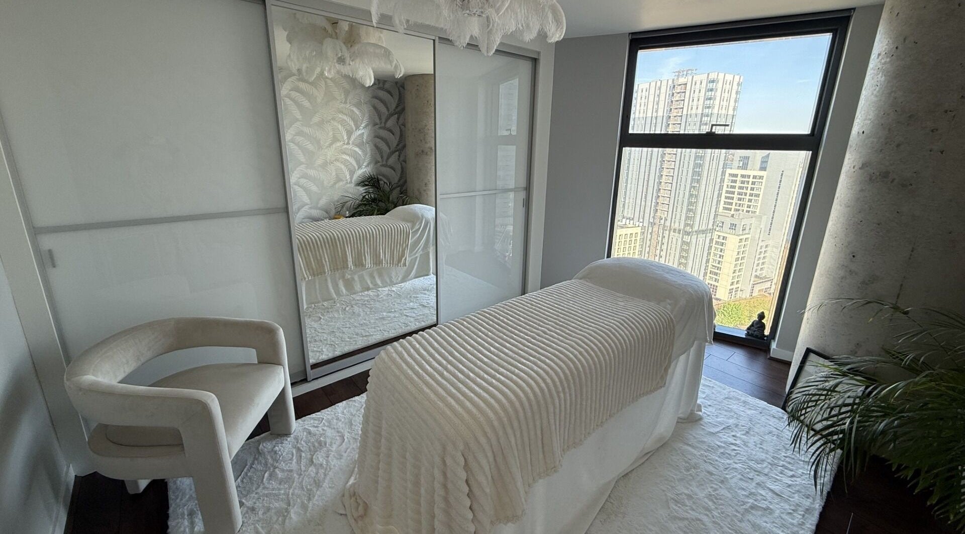 Luxurious treatment room at Luminosity Skincare & Holistic Therapies, Liverpool, England, GB with city view.