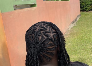 Intricate braided hairstyle at Hair Affair, Eastlynne, Saint George, BB, showcasing unique design.