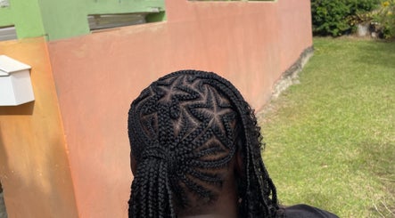Intricate braided hairstyle at Hair Affair, Eastlynne, Saint George, BB, showcasing unique design.