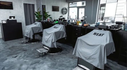 Modern barber chairs at SinayRkut in Paris, Île-de-France, FR, ready for clients in a stylish setting.