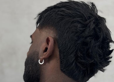 Close-up of a stylish haircut at SinayRkut, Paris, Île-de-France, FR, showcasing sleek and textured hair.