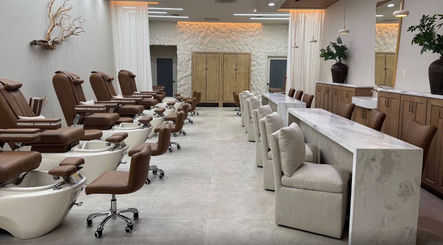 Chic interior of Zodiac Nail Boutique, Santa Clarita, CA, US, featuring plush chairs and modern decor.