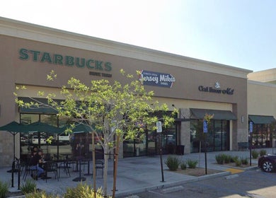 Zodiac Nail Boutique exterior at Santa Clarita, CA, showcasing inviting storefront and outdoor seating.