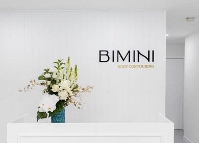 Entrance of Bimini Body Contouring in Melbourne, Victoria, AU with white flowers on a reception desk.