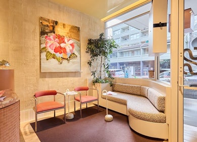 Cozy seating area at Sage Space, Darlinghurst, New South Wales, AU, featuring art and large windows.