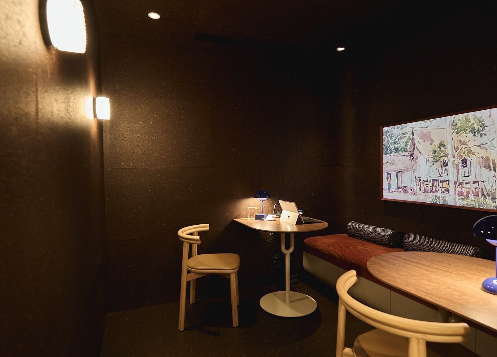 Intimate seating area at Sage Space, Darlinghurst, New South Wales, AU, featuring a table, chairs, and wall art.