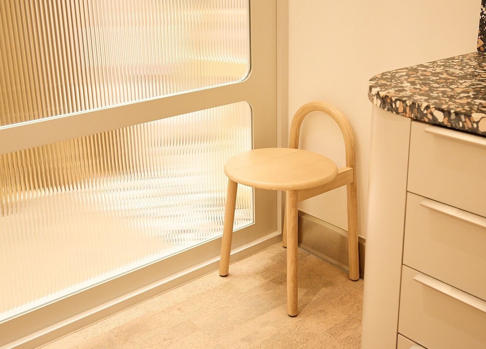 Cozy corner with wooden stool in Sage Space, Darlinghurst, New South Wales, AU.