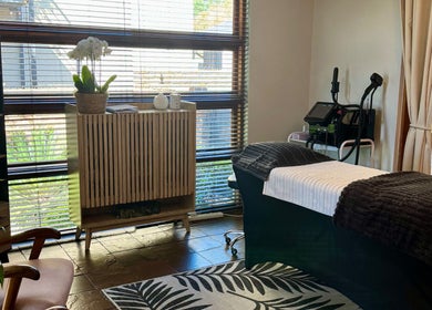 Calming spa room at Lumea Beauty Aesthetics, Centurion, Gauteng, ZA with cozy massage table and modern decor.