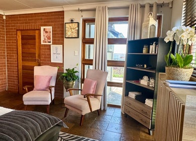 Cozy seating area in Lumea Beauty Aesthetics, Centurion, Gauteng, ZA with soft chairs and decorative plants.