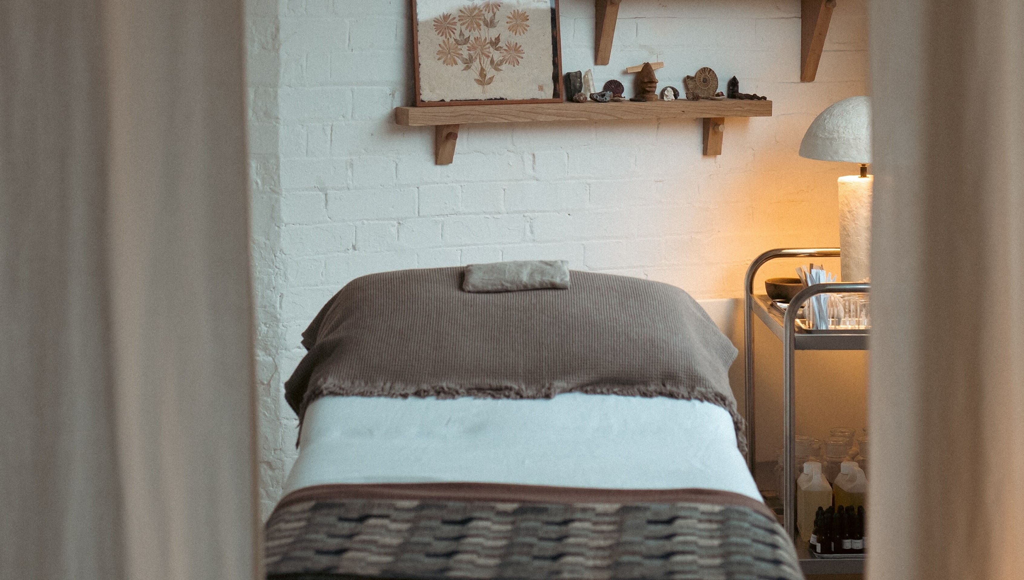 Massage bed in calming room at In Our Neighbourhood Apothecary, London, England, GB.