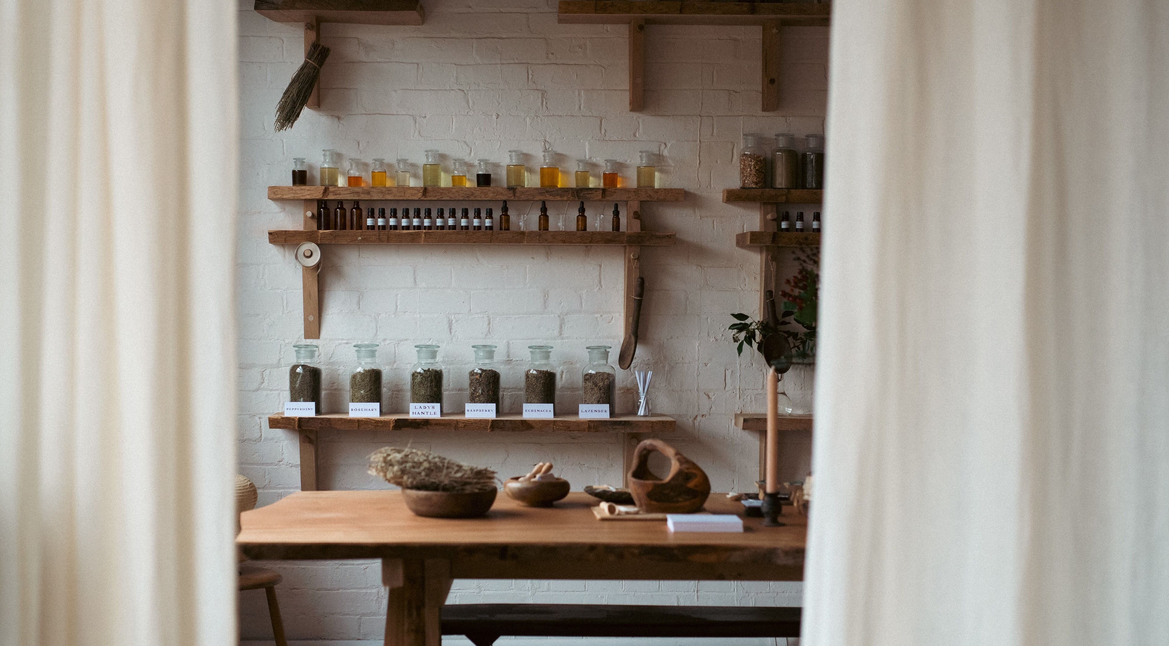 Herbal jars on wooden shelves at In Our Neighbourhood Apothecary, London, England, GB.