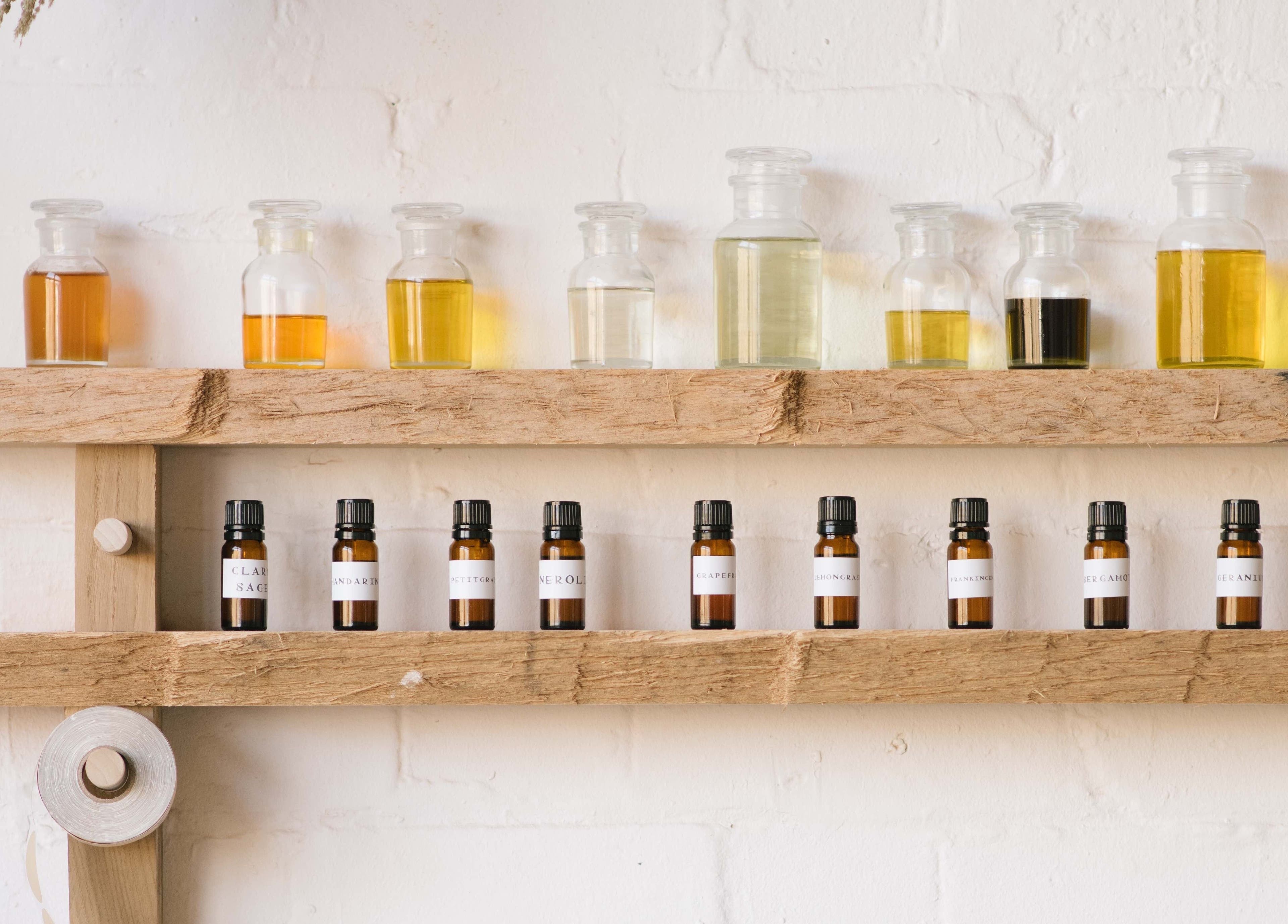 Natural oils on rustic shelf at In Our Neighbourhood Apothecary, London, England, GB.