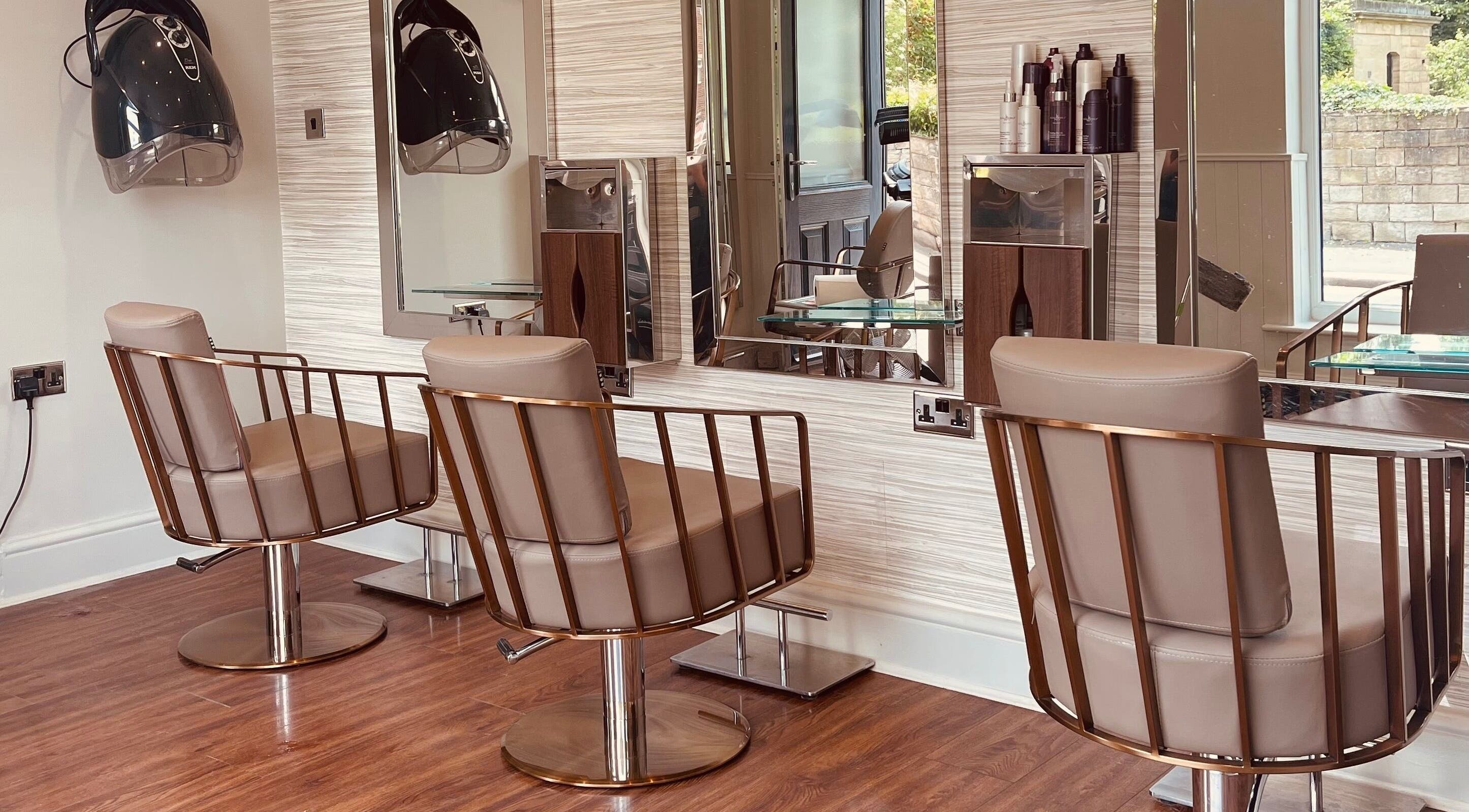 Stylish salon chairs and hair dryers at Zest Hairdressing, Horbury, England, GB, offering a relaxing space.