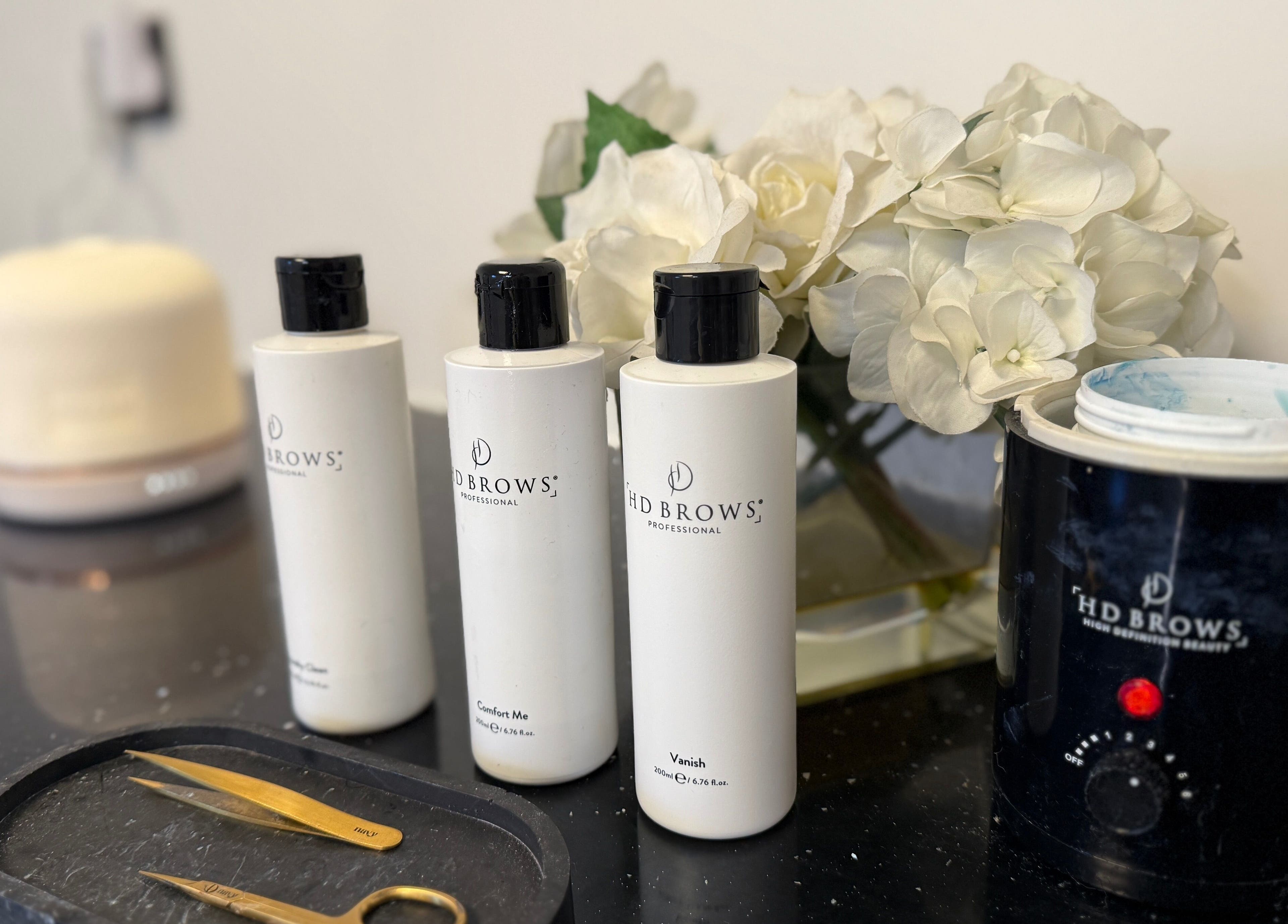 HD Brows products arranged at That Beaute Place in Alconbury, England, GB with elegant flowers.