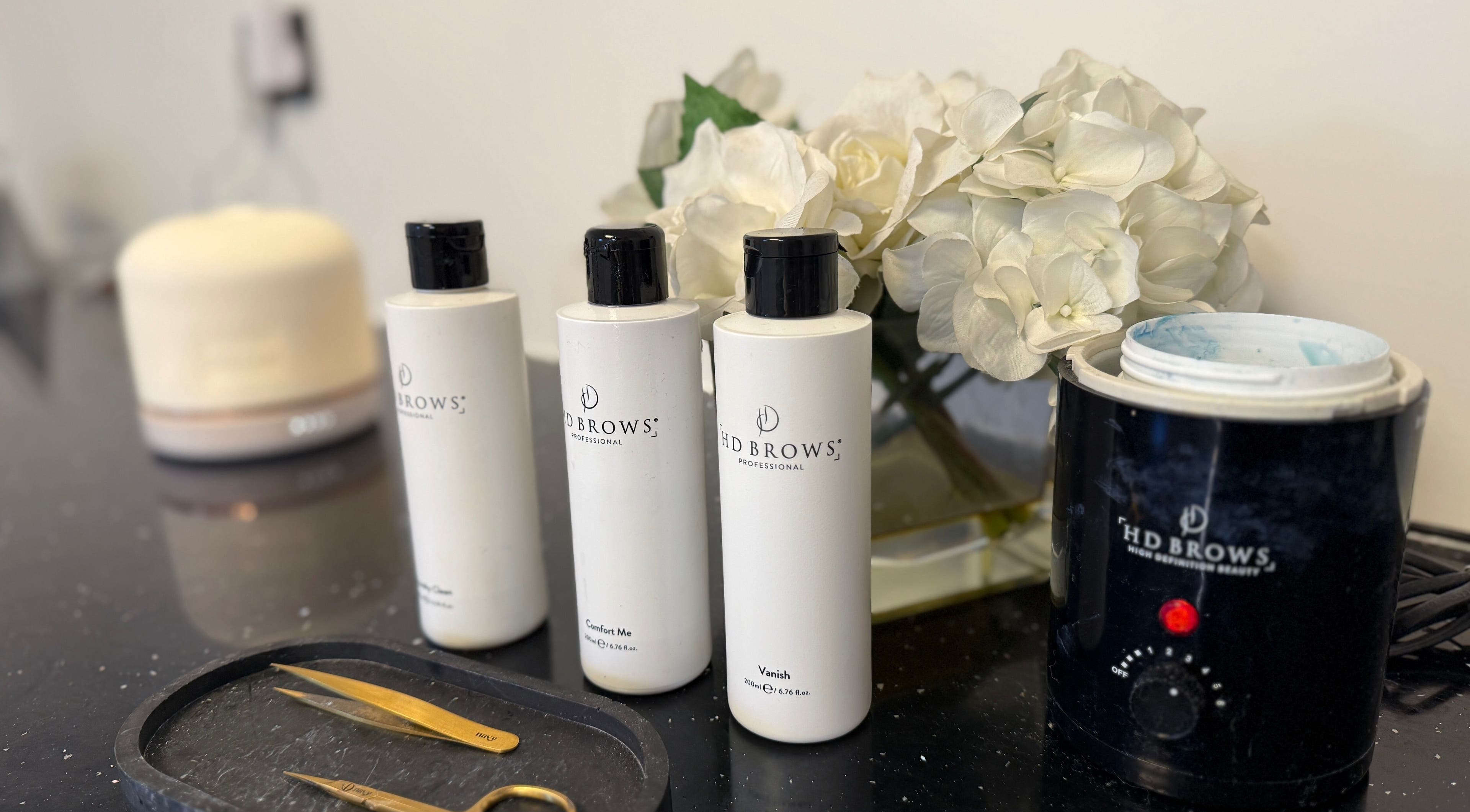 HD Brows products arranged at That Beaute Place in Alconbury, England, GB with elegant flowers.