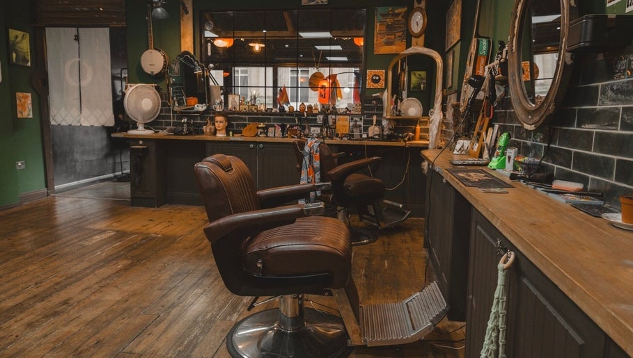 Charming interior of Lost & Found, Sheffield, England, GB, featuring vintage barber chairs and a cozy atmosphere.