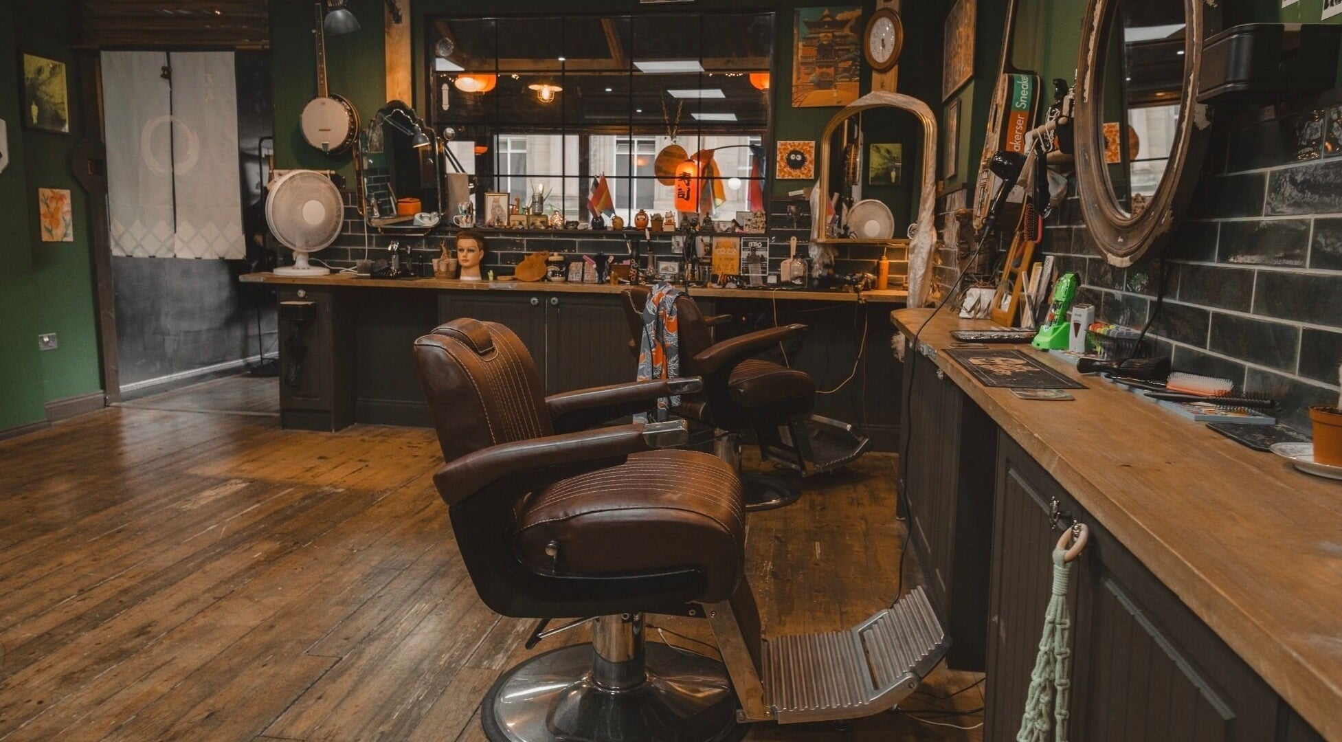Charming interior of Lost & Found, Sheffield, England, GB, featuring vintage barber chairs and a cozy atmosphere.