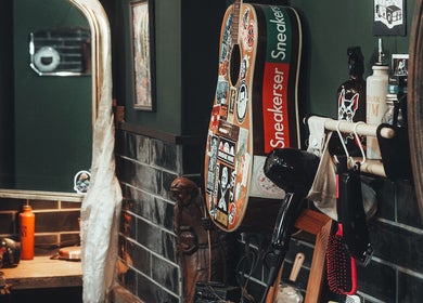 Stylish salon corner at Lost & Found, Sheffield, England, GB, with guitar decor and hair styling tools.