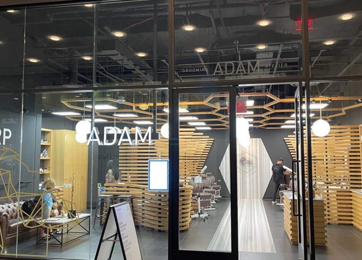 Exterior view of Adam Grooming Atelier - Brookfield Place, New York, showcasing chic interior with grooming stations.