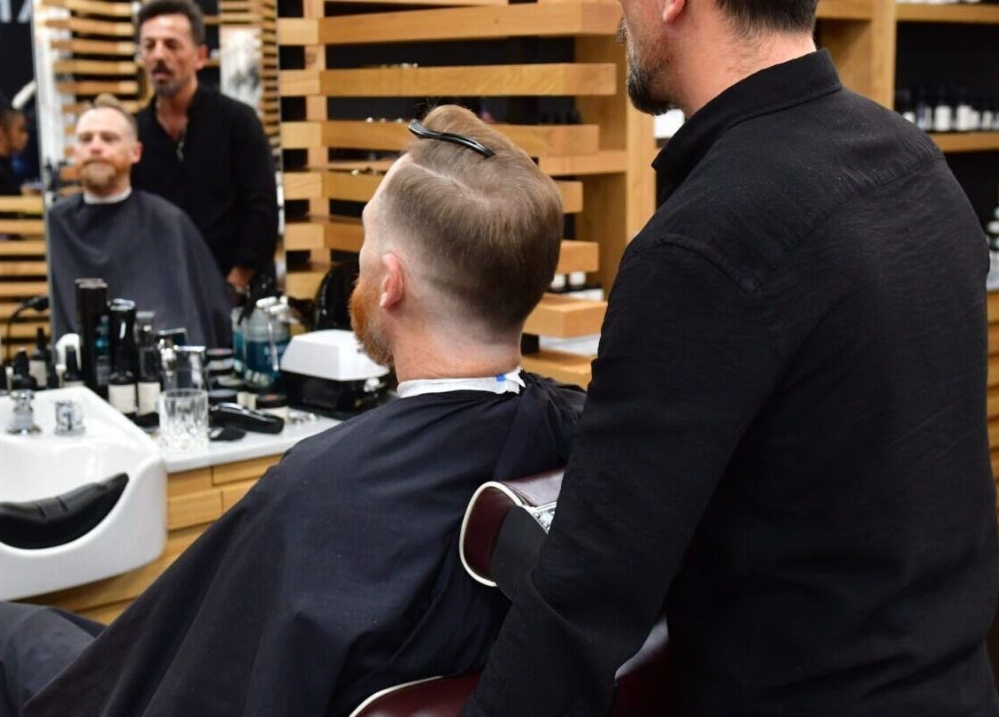 Haircut session at Adam Grooming Atelier - Brookfield Place, New York, New York, US showcasing sleek interior.