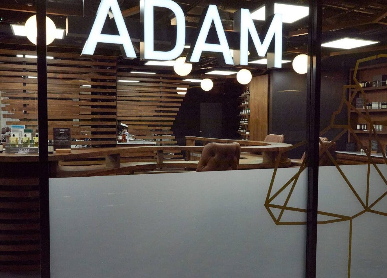 Modern interior of Adam Grooming Atelier - Brookfield Place, New York, New York, US with stylish decor.