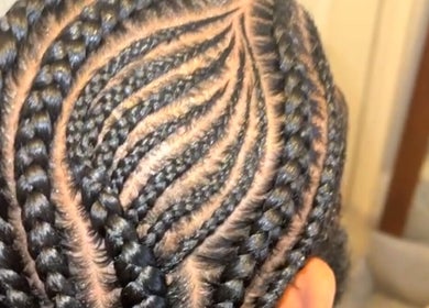 Elegant braided hairstyle at Braided By Ri in Gillingham, England, GB showcasing detailed patterns.