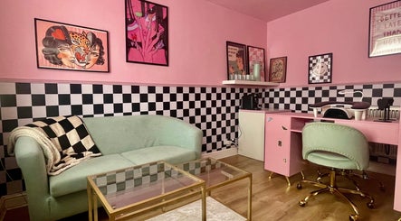 Stylish pink interior of Nova Nails in Pontypridd, Wales, GB, featuring chic seating and a modern nail station.
