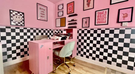 Chic and modern nail station at Nova Nails, Pontypridd, Wales, GB, with pink decor and polish displays.