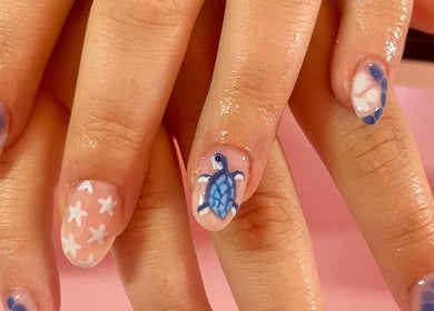 Blue and white nail art with turtle design at Nova Nails, Pontypridd, Wales, GB.