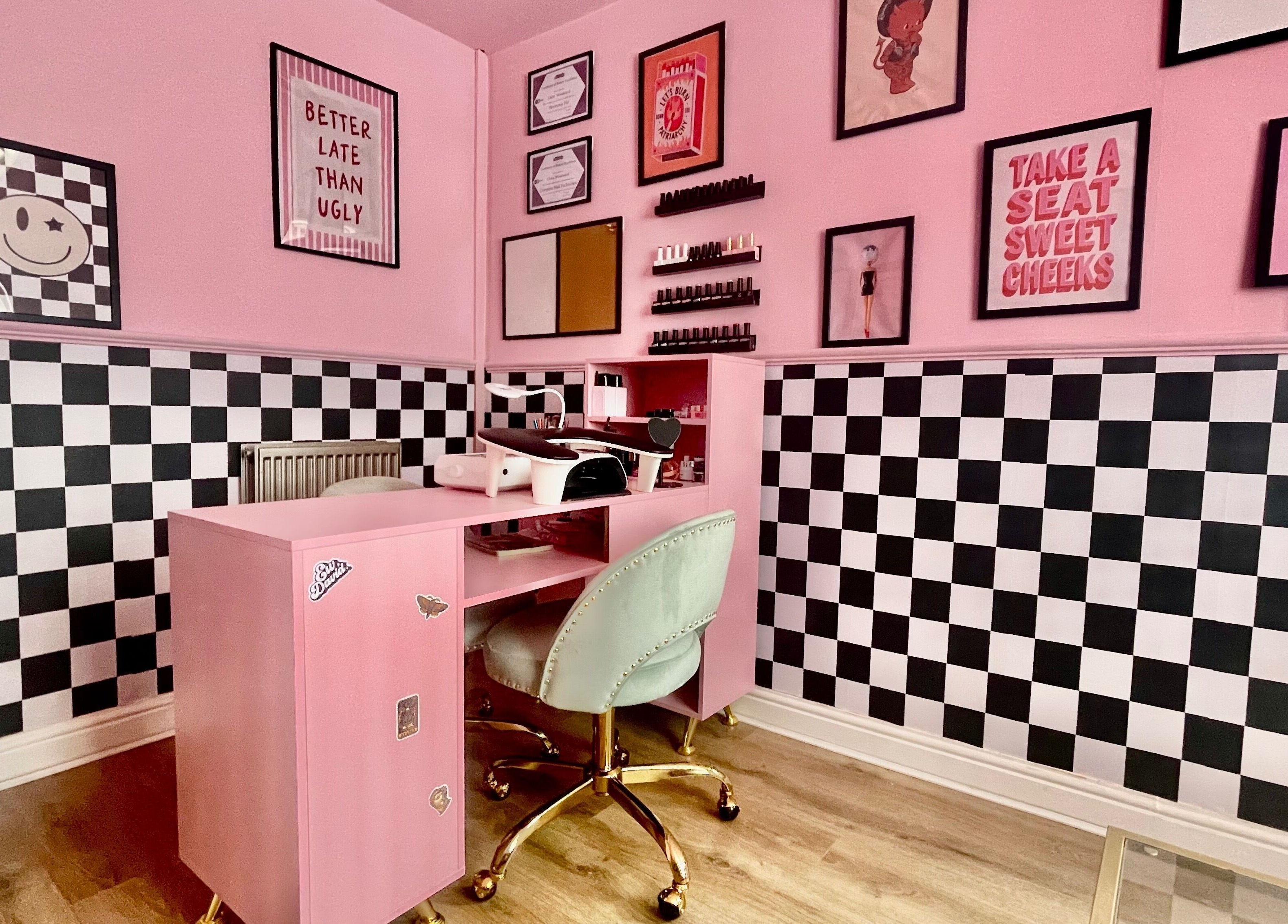 Nova Nails studio in Pontypridd, Wales, GB featuring stylish pink decor and checkered walls.