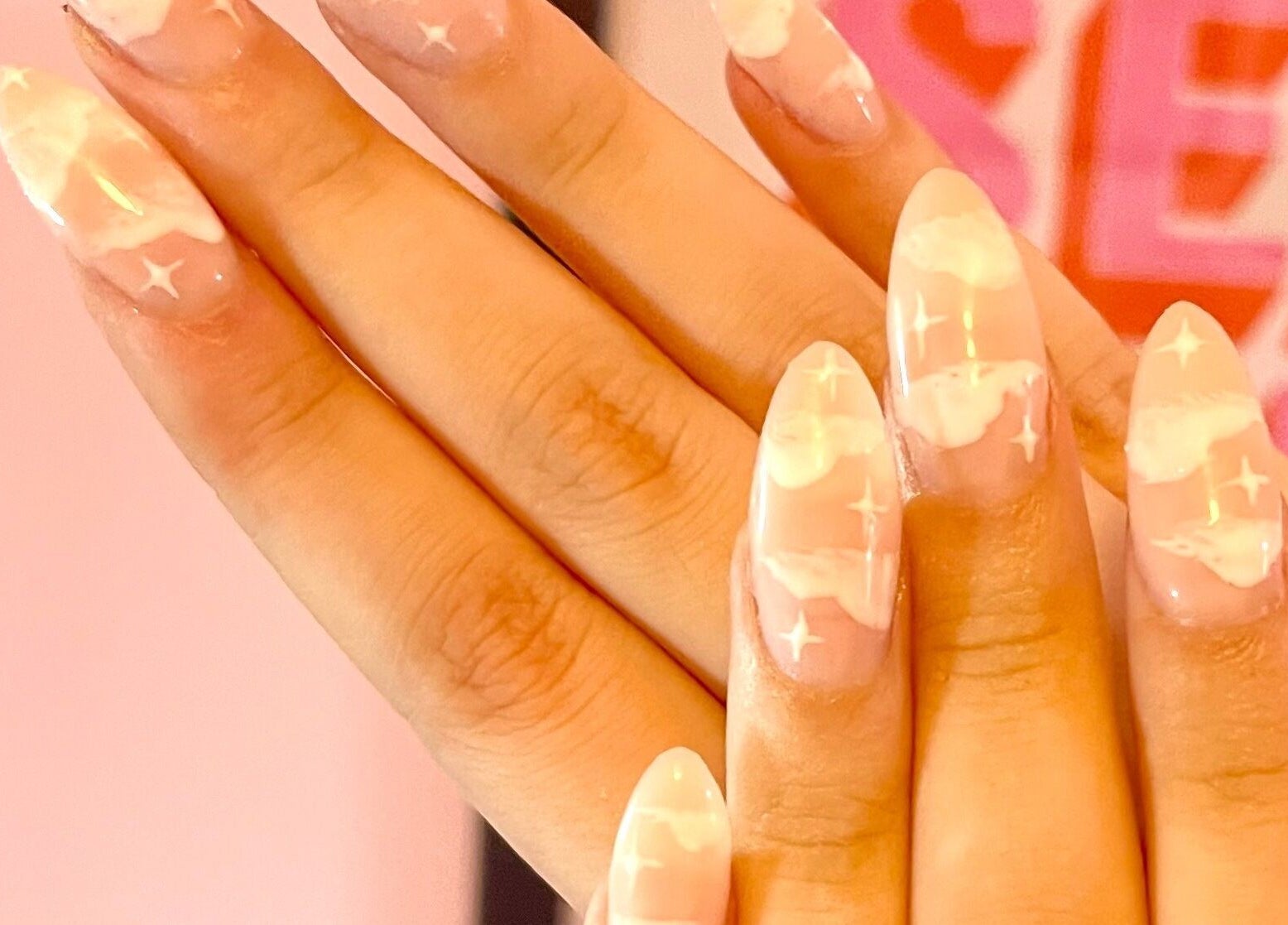 Elegant celestial-themed manicure at Nova Nails, Pontypridd, Wales, GB, featuring pink and white accents.