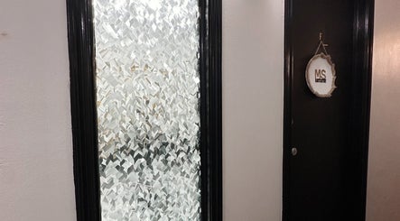 Decorative MS Artistry door at MariahSavisArtistry, Mabank, Texas, US, featuring textured glass paneling.