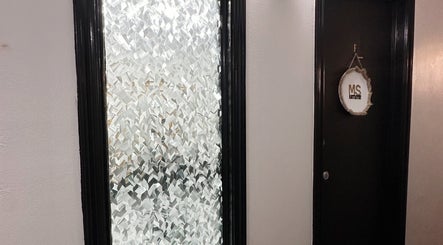Elegant entrance of Mariah Savis Artistry with textured glass in Mabank, Texas, US.