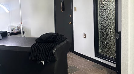 Modern treatment room at Mariah Savis Artistry, Mabank, Texas, US, featuring a sleek massage table and cozy ambiance.