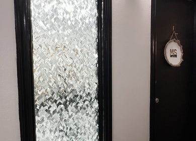 Entrance of Mariah Savis Artistry in Mabank, Texas, US, featuring a decorative frosted glass window.
