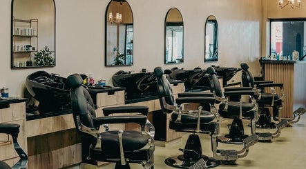 Interior of Blade & Banter Barbershop in Midrand, Gauteng, ZA with stylish black barber chairs and mirrors.