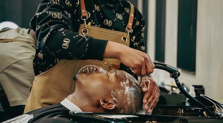 Client enjoys a refreshing haircut wash at Blade & Banter Barbershop, Midrand, Gauteng, ZA.