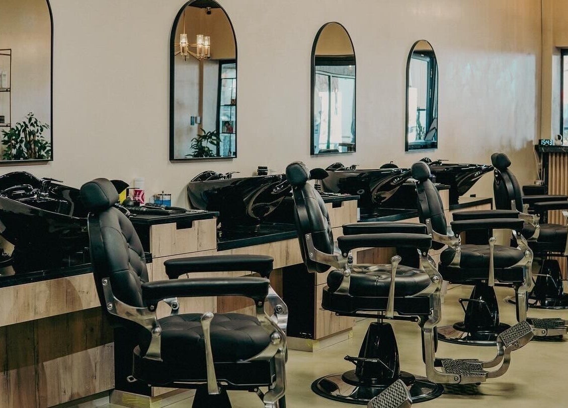 Modern barber chairs at Blade & Banter Barbershop, Midrand, Gauteng, ZA. Elegant salon setting.