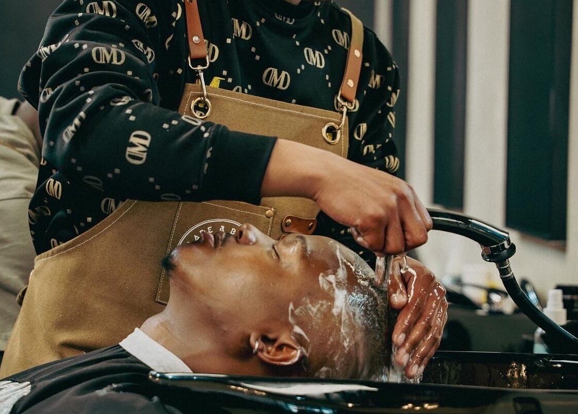 Guest enjoying a hair wash at Blade & Banter Barbershop, Midrand, Gauteng, ZA.