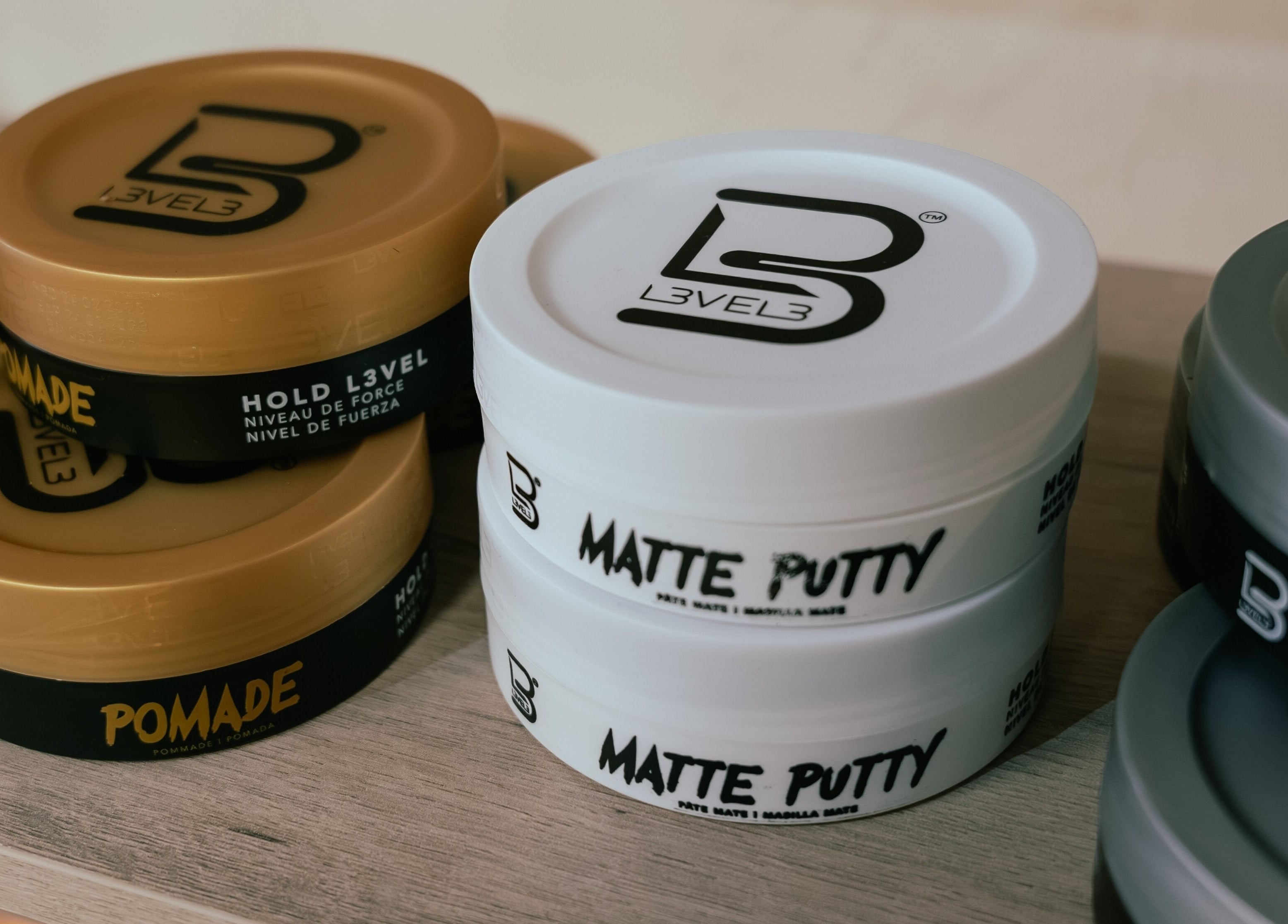Hair products display at Blade & Banter Barbershop, Midrand, Gauteng, ZA, showcasing pomade and matte putty.
