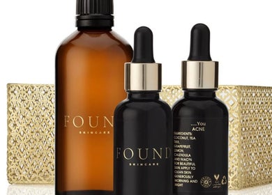 Elegant skincare bottles from Found Skin, Mount Maunganui, Bay Of Plenty, NZ with intricate golden accents.