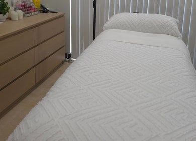 Relaxing treatment room at Omni Skin Clinic in Brabham, Western Australia, with a plush bed and cozy ambiance.