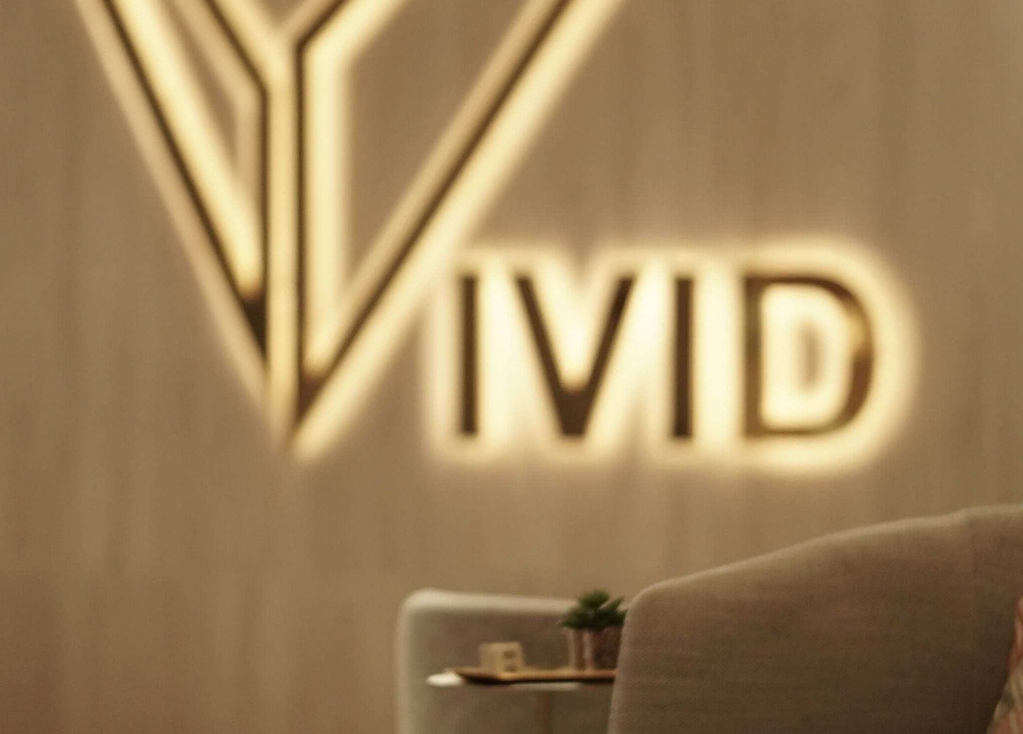 Elegant Vivid Fitness and Spa logo in Al Khobar, Eastern Province, SA on soothing interior backdrop.