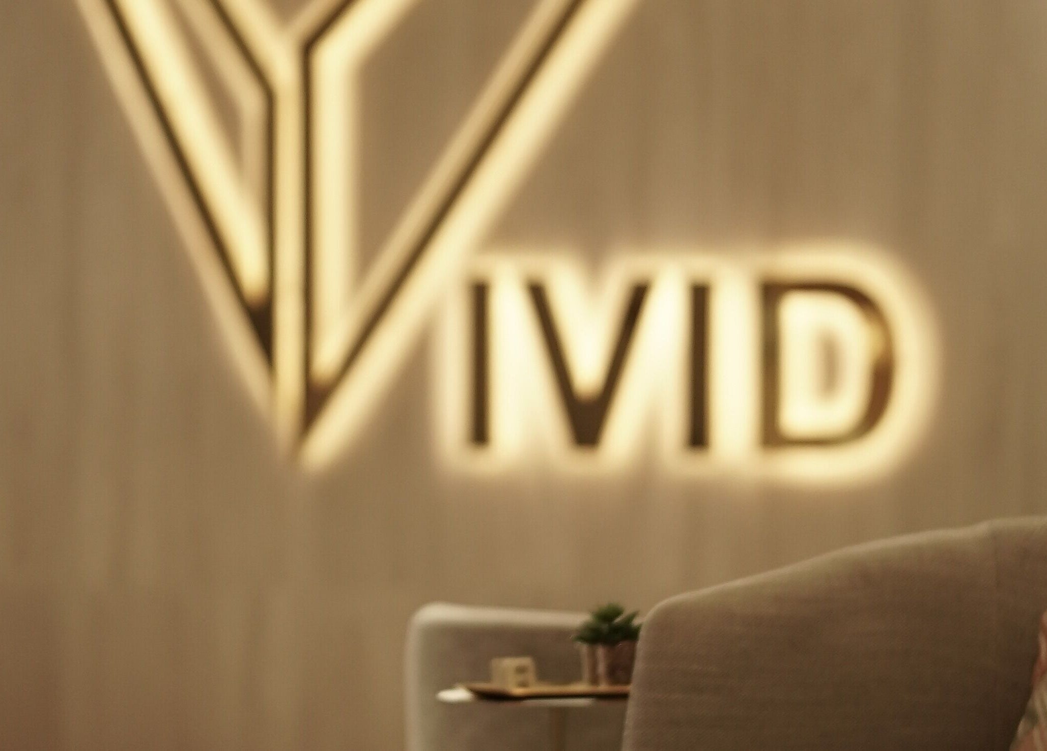 Elegant Vivid Fitness and Spa logo in Al Khobar, Eastern Province, SA on soothing interior backdrop.